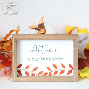 The "Autumn Pumpkin Patch Signs" feature a beautifully framed design with the words "Autumn is my favourite" elegantly written in a blue script font. Below this heartfelt message, you'll find a decorative border adorned with red and orange autumn leaves, complemented by an assortment of fall leaves surrounding the frame. This sign is perfect for your Autumn Decor and showcases the KC Cottage logo in the upper left corner.