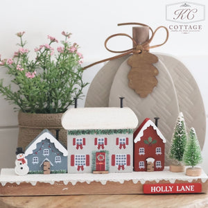 Christmas Cottage Holly Lane Row Of Wooden Houses, Trees And Snowman Block