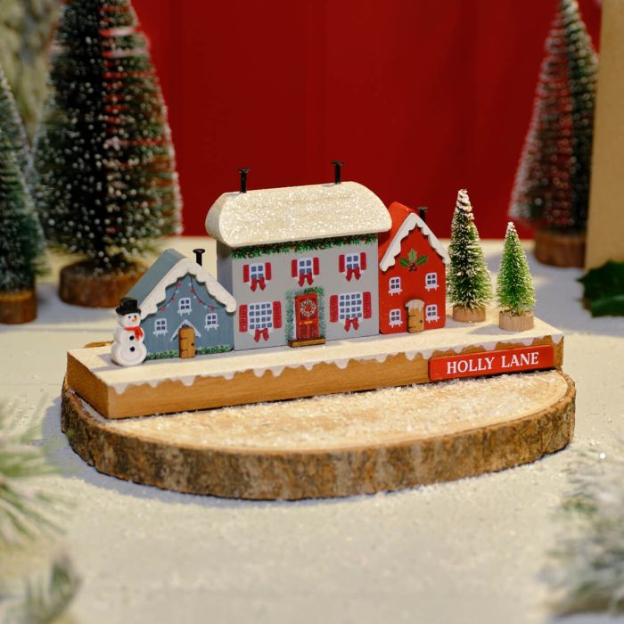 Christmas Cottage Holly Lane Row Of Wooden Houses, Trees And Snowman Block