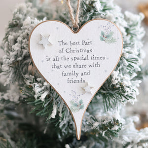 A Christmas Sentiment Heart Hanger With 3D Star, featuring decorative 3D stars and a pine branch, hangs on a snow-covered Christmas tree. The ornament displays the message: "The best part of Christmas is all the special times that we share with family and friends.