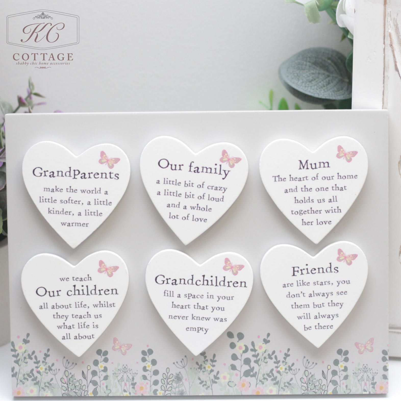 A decorative Butterfly Family Heart Magnets with six heart-shaped signs, each featuring a sentimental message. Text includes: "GrandParents," "Our family," "Mum," "Our children," "Grandchildren," and "Friends." The plaque is surrounded by a floral border and butterfly designs.