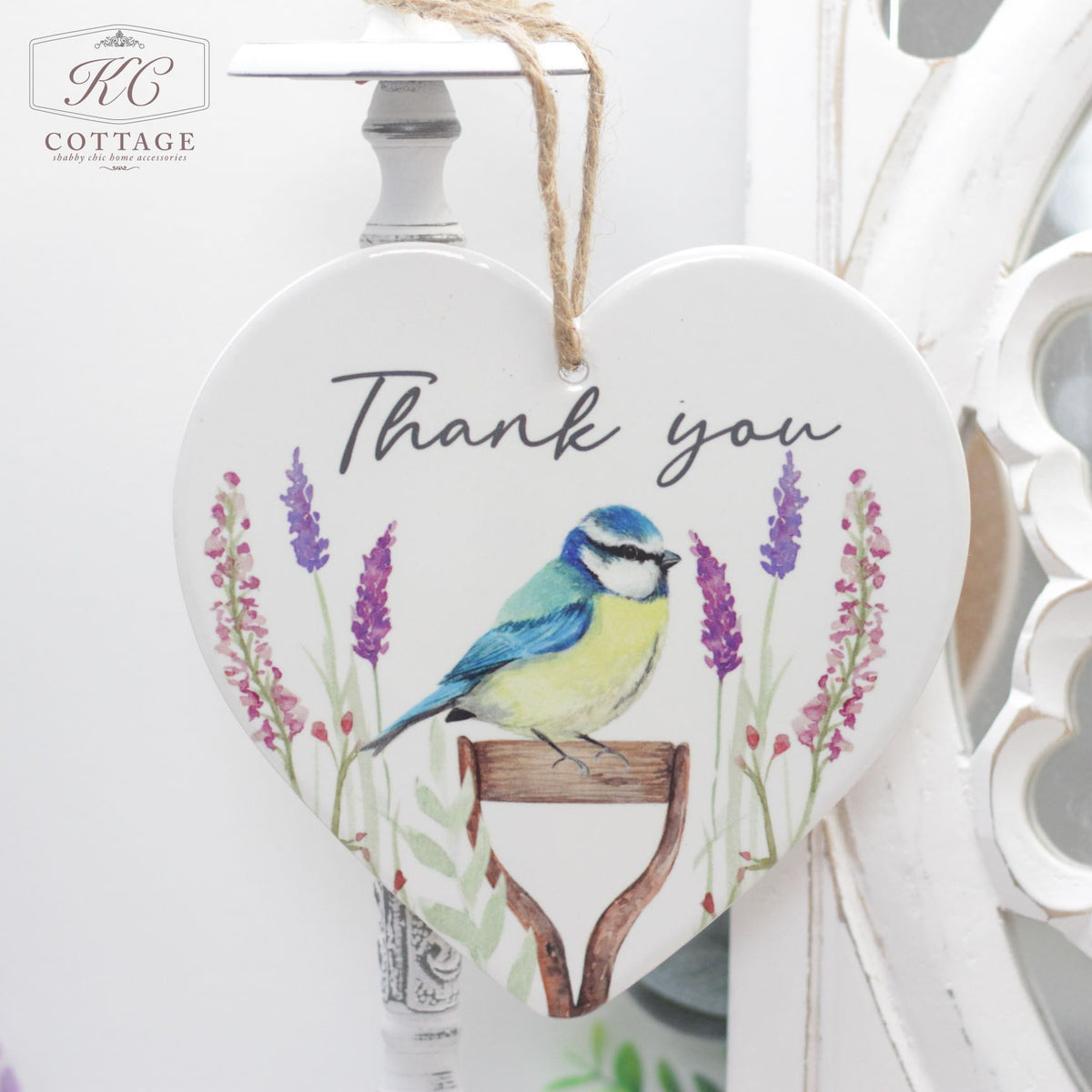 A Bluetit Thank You Ceramic Hanging Heart with the text "Thank you." The heart features an illustration of a blue and yellow bird perched on a gardening tool surrounded by lavender flowers.